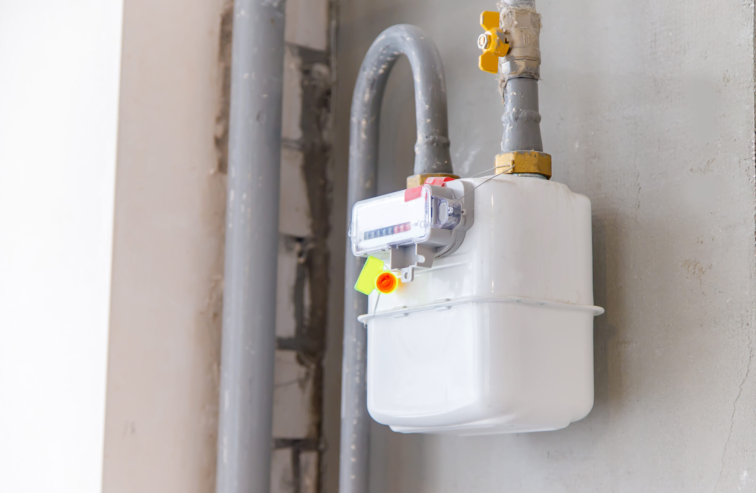 gas meter on the wall in the house. Selective focus. white.